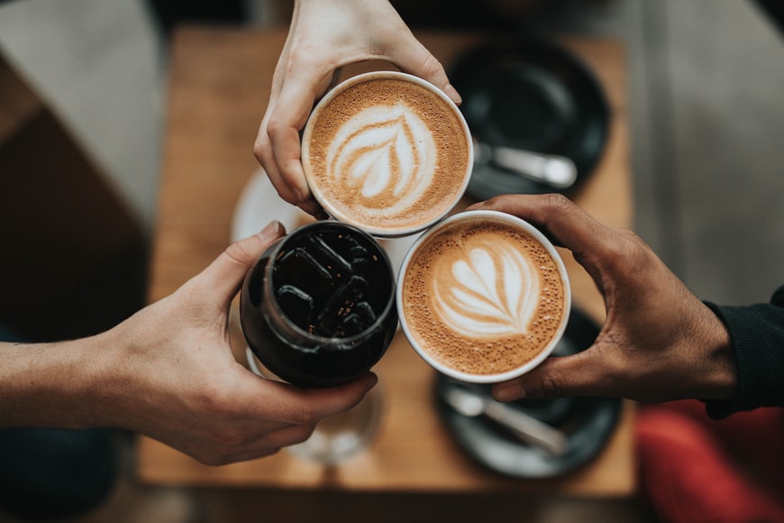 Three people holding coffees image